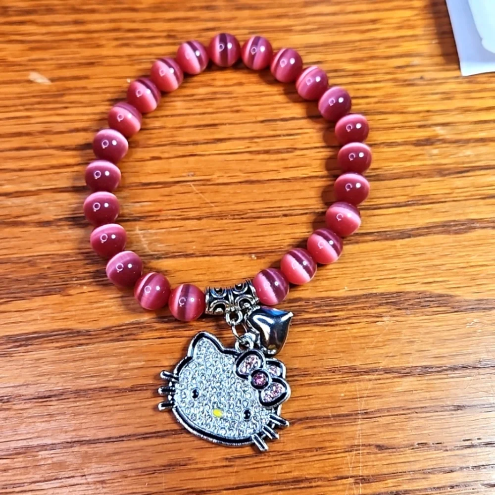 NWT Luminous "Hello Kitty" Pink Cat Eye Stretch Bracelet - Picture 1 of 3